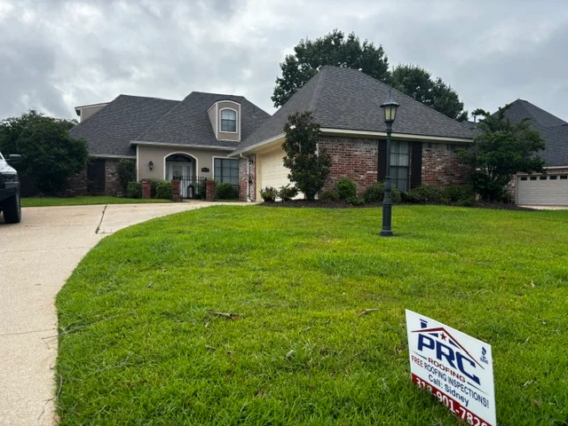 Two-story home with new charcoal gray asphalt shingle roof, brick and stucco exterior