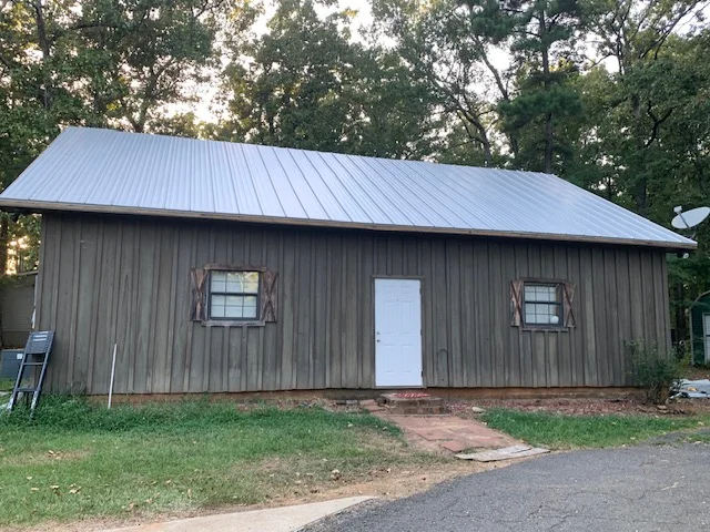Standing seam metal roof with gray finish on residential building with metal siding